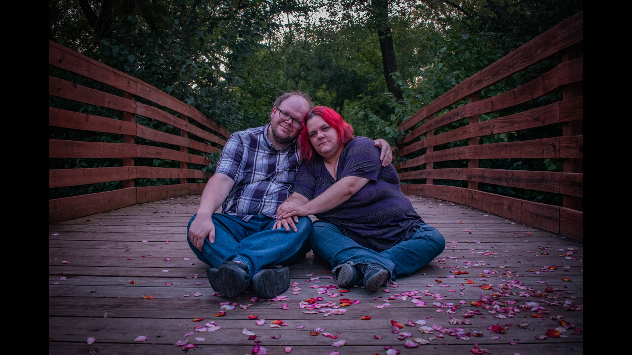 Alex and Danni sitting in center of bridge.