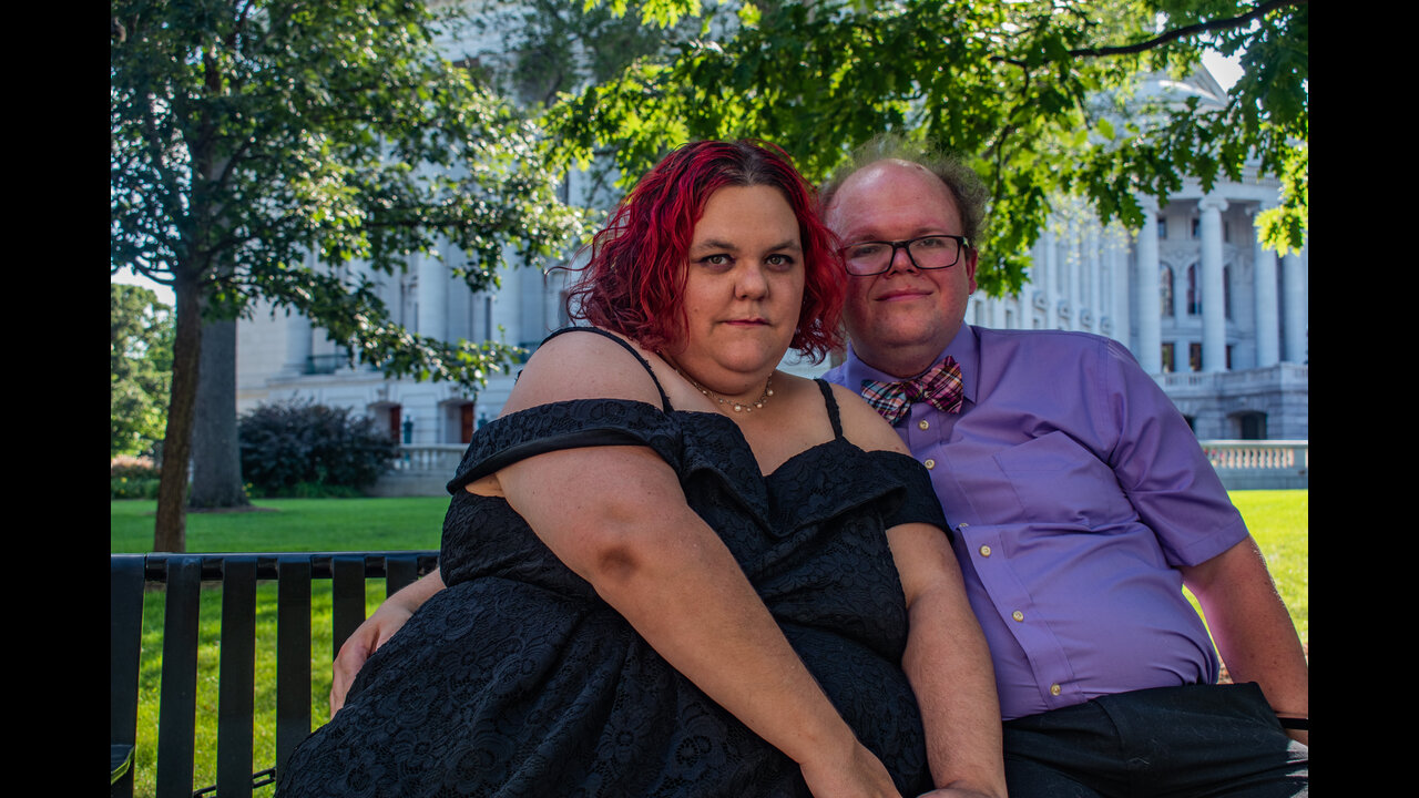 Danni and Alex sitting on bench in front of the Wisconsin State Capitol.